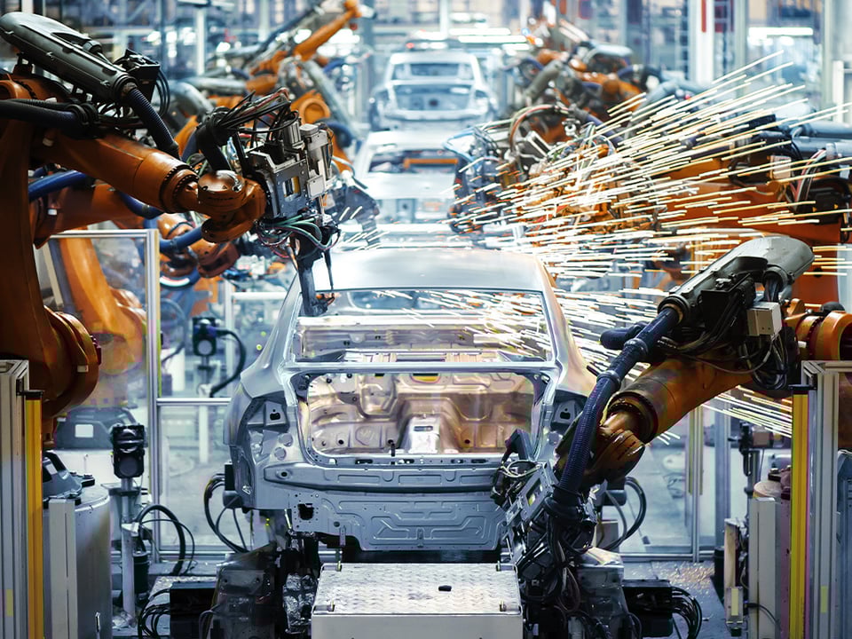 Automotive manufacturing - robots welding on car frames
